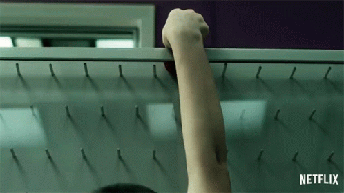 Hand dropping a puck into a plinko board